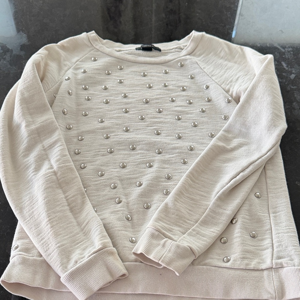 Cream colored sweatshirt with silver accents